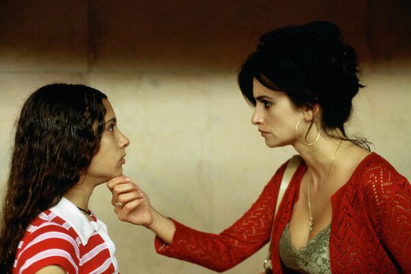 Penelope Cruz holding a girl's chin