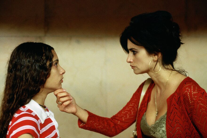 Penelope Cruz holding a girl's chin
