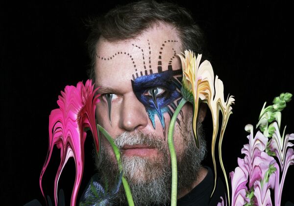 A distorted image of John Grant and flowers