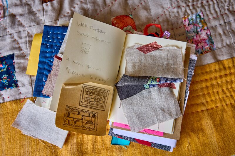 Julia O'Connell's notebook with sketches and fabric samples.