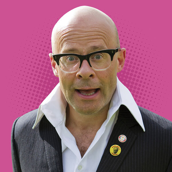 Harry Hill wearing his trademark high white collared shirt, with a bright pink background