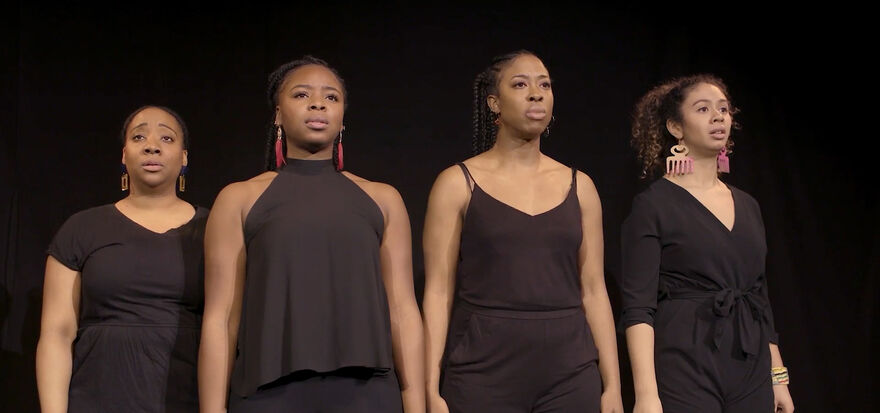 Four black women standing in a row