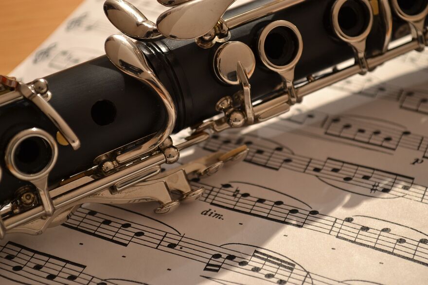 Close up shot of a clarinet sat on sheet music