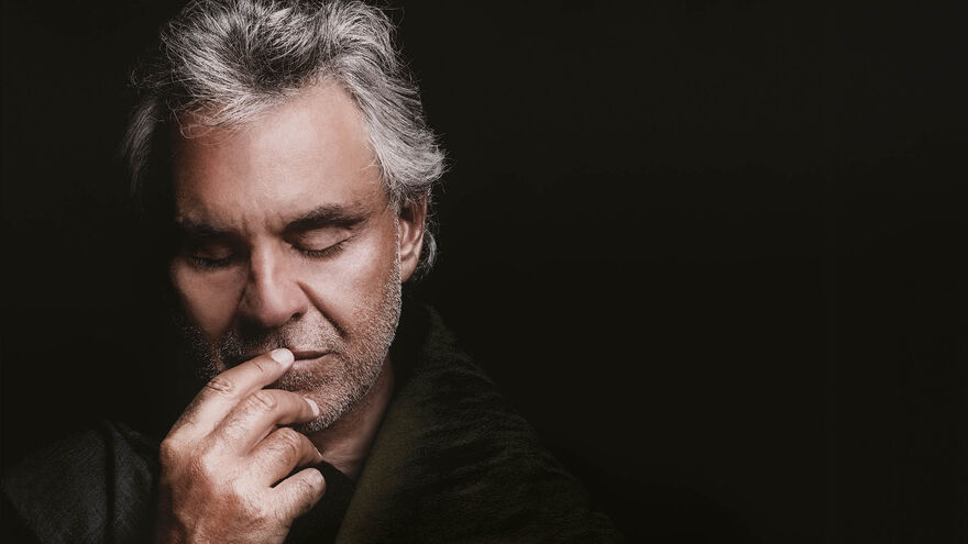 Andrea Bocelli against a black background.