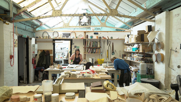 Two ceramicists working in a ceramics studio