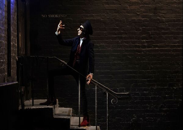 John Cooper Clarke standing on a stairwell