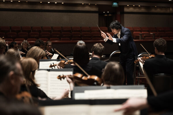 Conductor leading an orchestra 