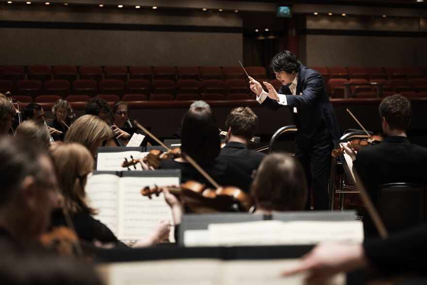 Conductor leading an orchestra
