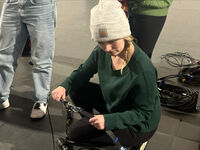 Woman holding lighting cables and straps