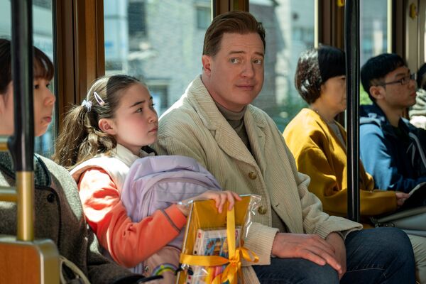 A man sits next to a young girl on a bus. 
