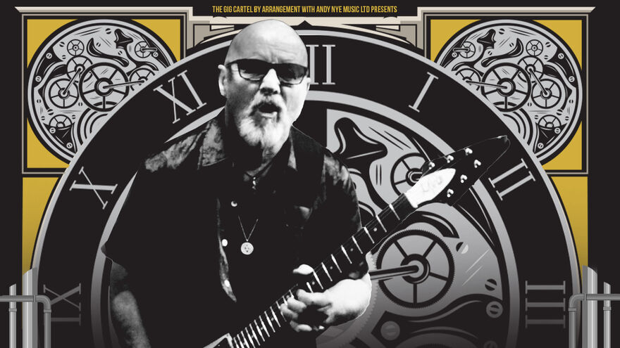 A man plays a rock guitar with a clock behind him 