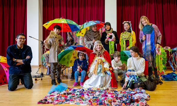 A group of people holding colourful umbrellas