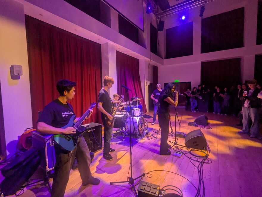 A band plays in front of onlookers 