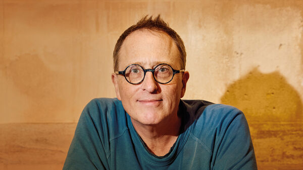 Jon Ron in a blue shirt and glasses