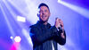 Nathan Carter on stage holding a microphone