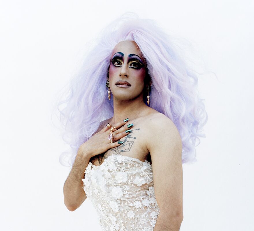 Glamrou in a wedding dress with lilac hair and purple make-up
