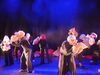 Group of dancers breathing into large paper bags