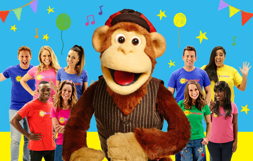 Milkshake Monkey with 9 Milkshake presenters behind 