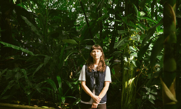 Jasmine Myra standing in front of foliage