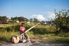 Gasper Nali seated outdoors holding a babatoni bass guitar.