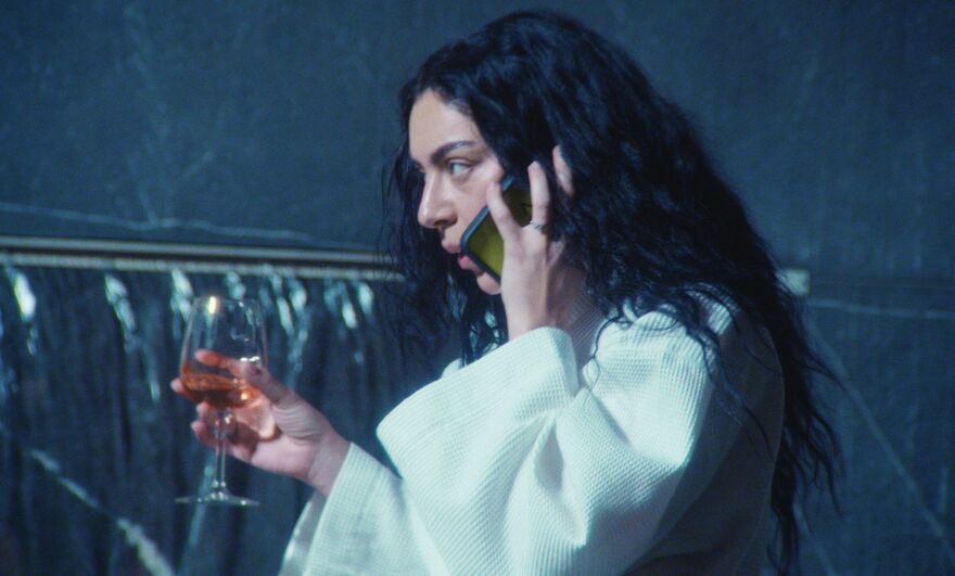Charli XCX Holding a wine and a glass of rose