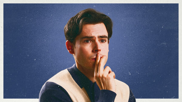 A  portrait of comedian Rhys James with a thoughtful expression.