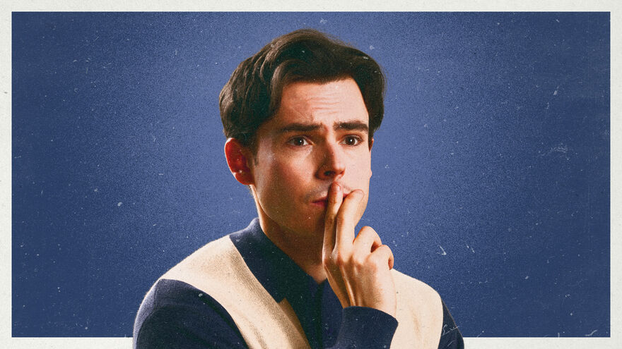 A  portrait of comedian Rhys James with a thoughtful expression.