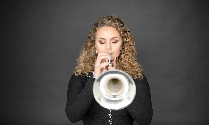 Matilda Lloyd playing a trumpet