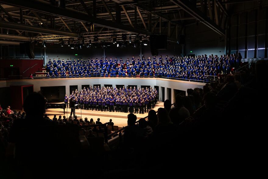 Children singing in a choir on stage