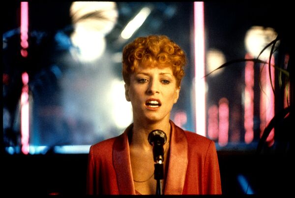 A woman sings into a microphone. A woman sings into a microphone.