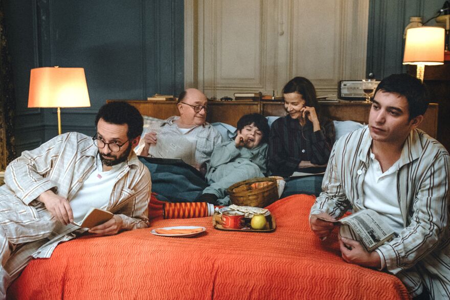 A family in pyjamas all sat on a bed