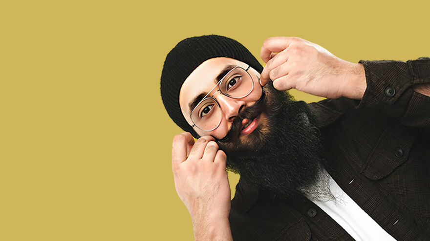 Man with beard swirling his moustache