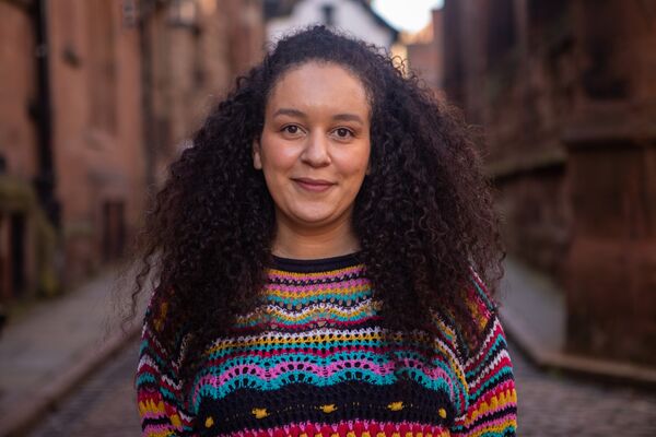 A portrait of Jenine Martin smiling outdoors.