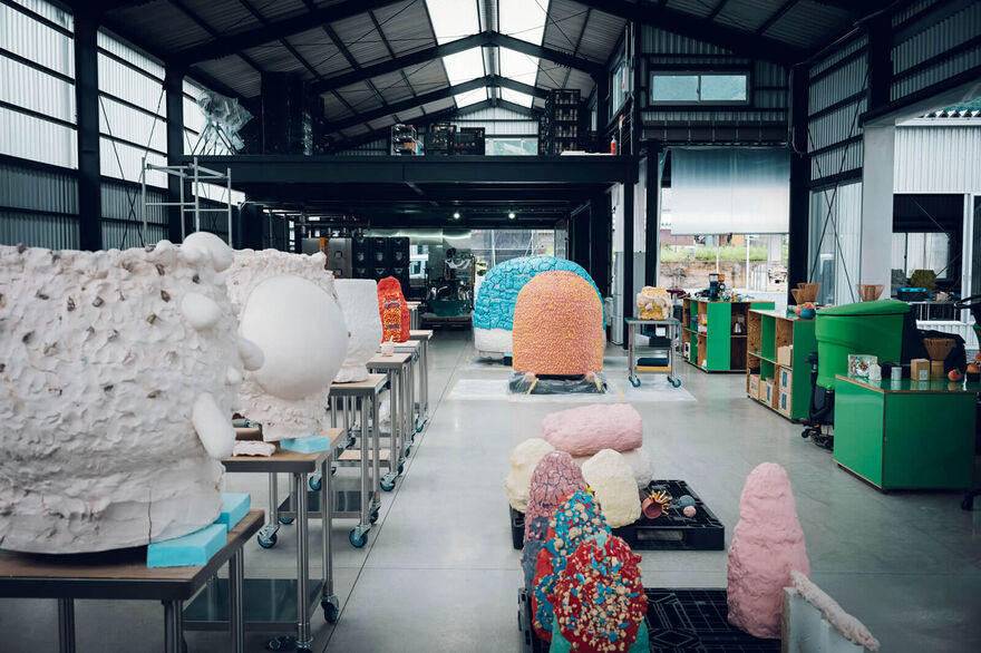 A collection of colourful sculptures in a warehouse
