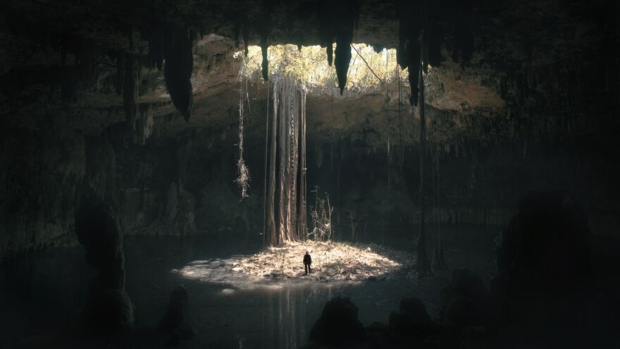 A large subterranean space with light cascading from above.