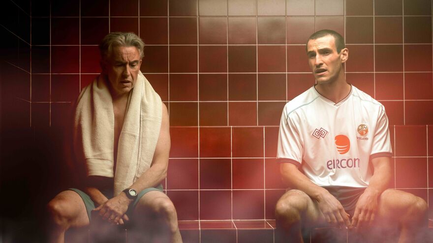 Two men sit together in a sauna. 