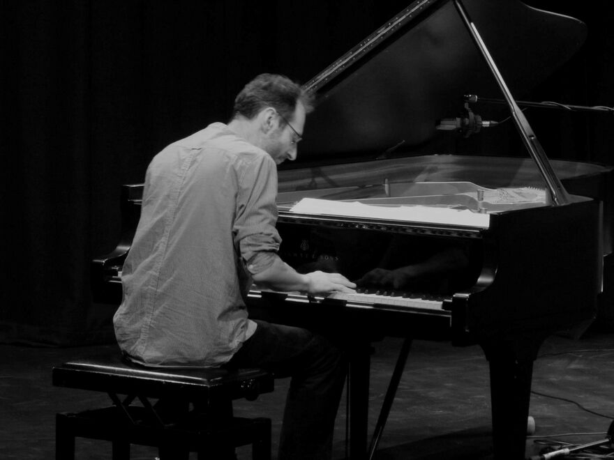 Black and white photo of David Gordon playing the piano