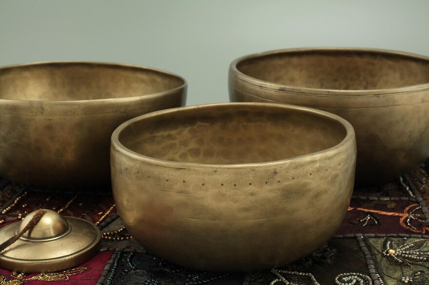 Three singing bowls on an embroidered cloth