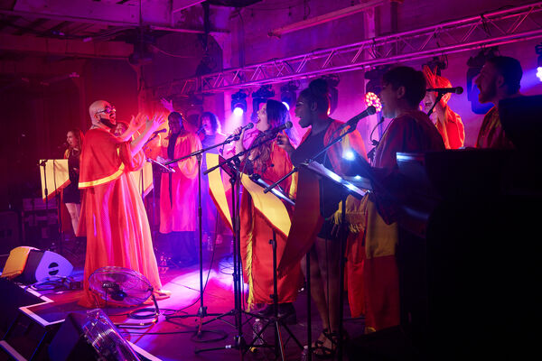 Fatt Butcher and a gospel choir on stage