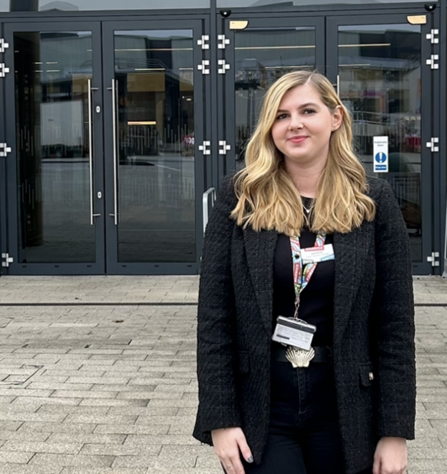Beth stands proudly outside the new Warwick Arts Centre entrance
