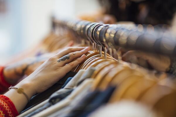 Hand on a rail of clothing 