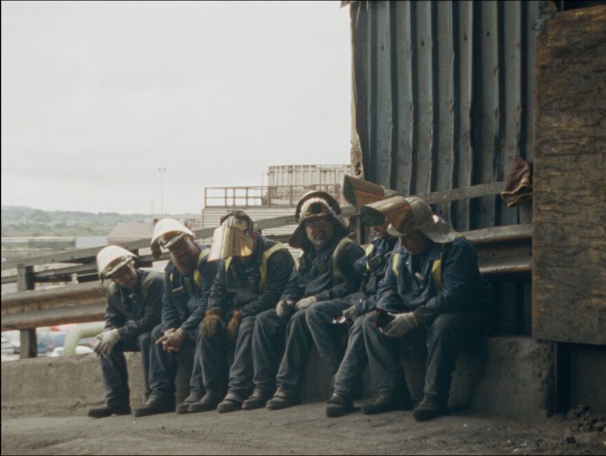 A group of steel workers take a break. 