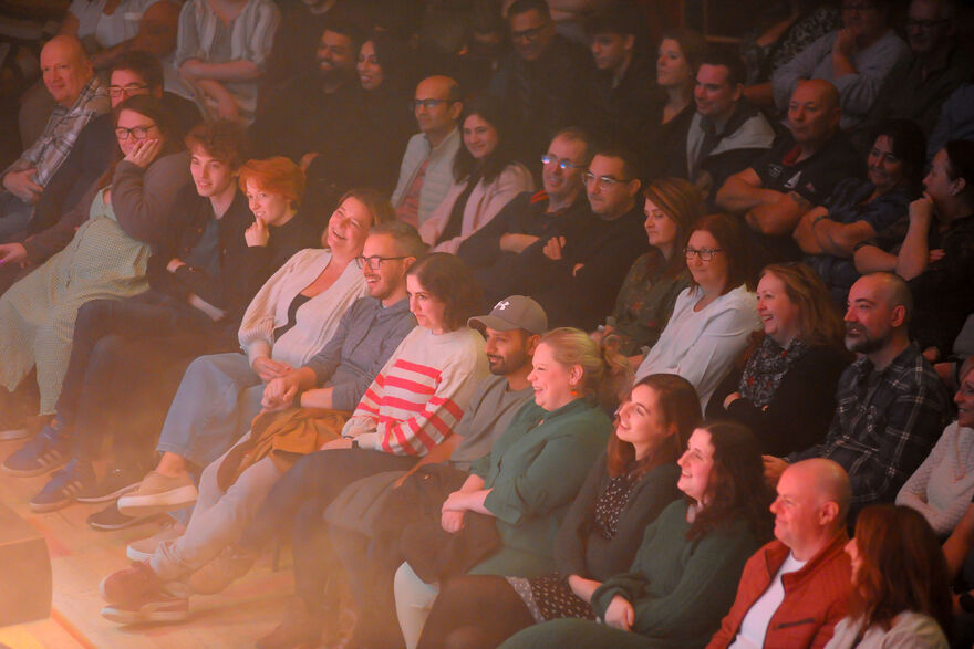 Auidence members smiling and laughing