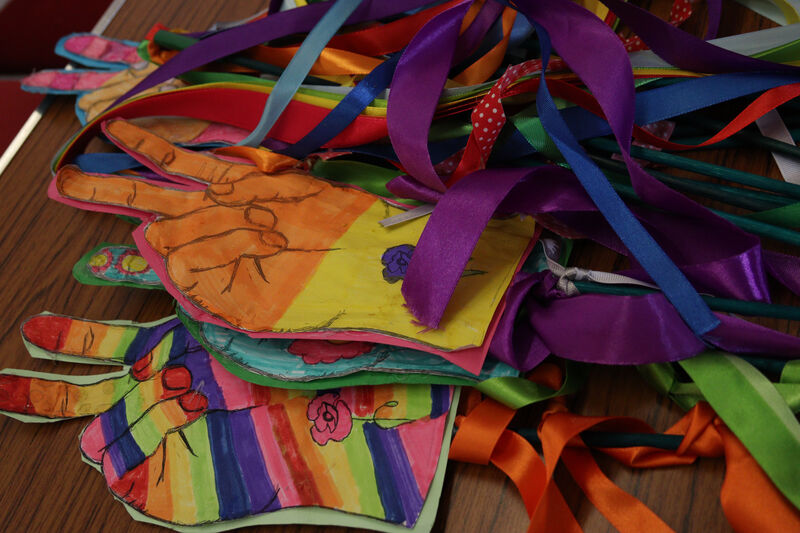 A close-up of a collection of handmade props lying on a wooden table.