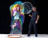 Amazing Bubble Man next to woman inside of a bubble
