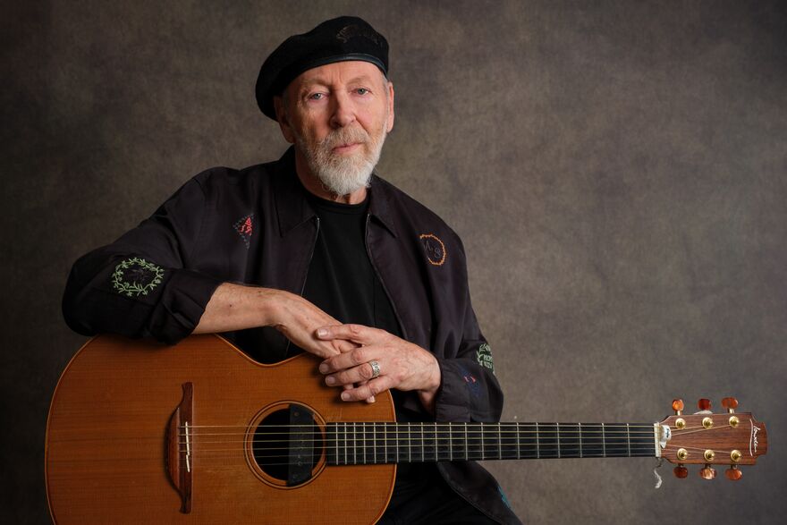 Richard Thompson leaning on a guitar