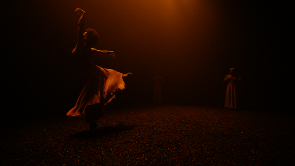 A ballet dancer bathed in orange light. 