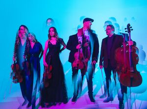 4 people holding instruments with motion blur 