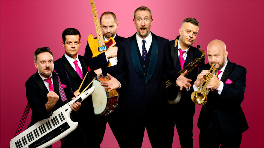 The Horne Section wearing suits and holding their instruments
