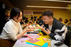 Two students both holding origami 